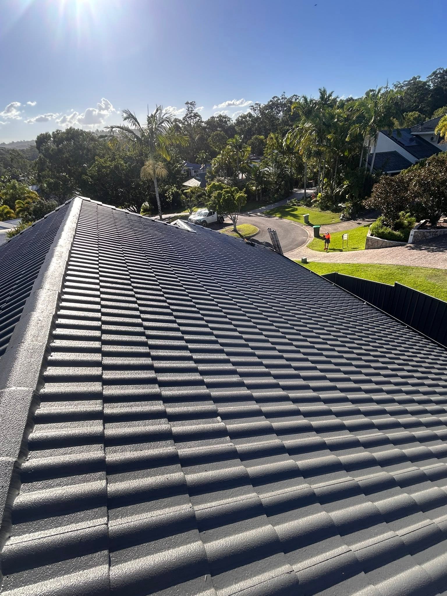 Freshly restored and sprayed charcoal tile roof on the Sunshine Coast